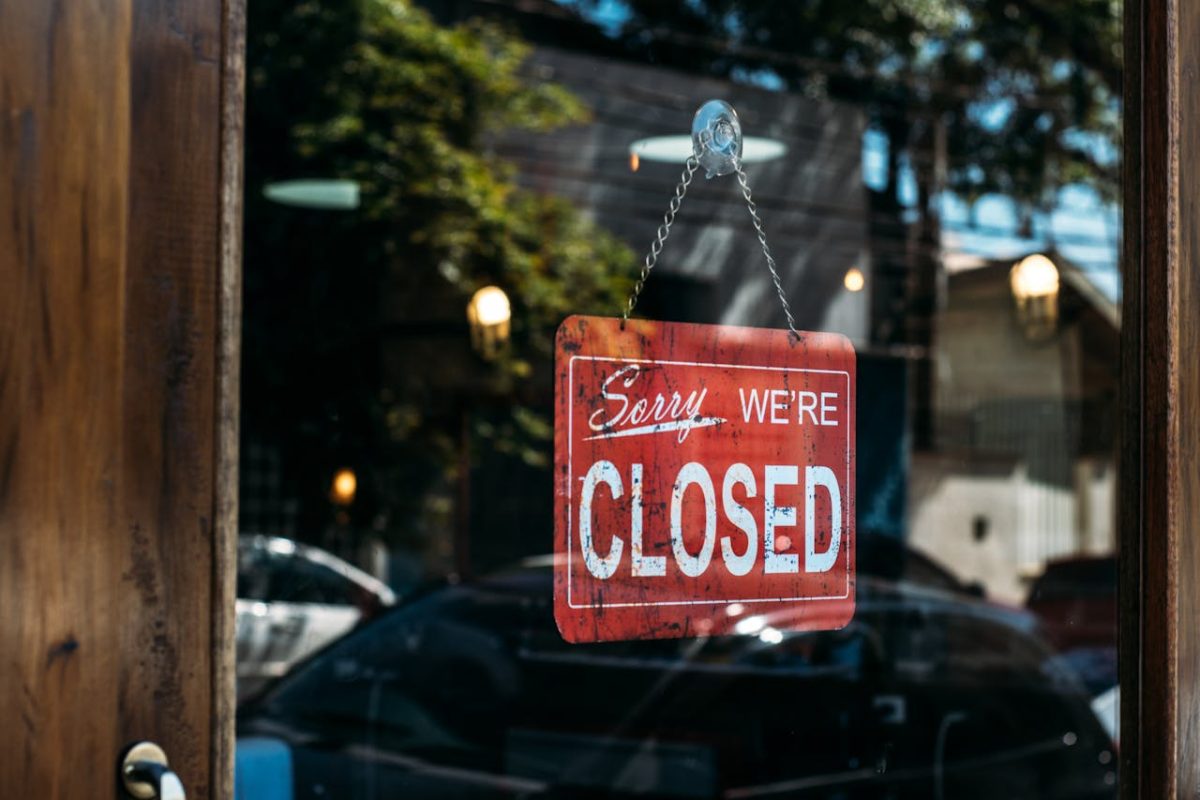 A retail business closed sign in the window.