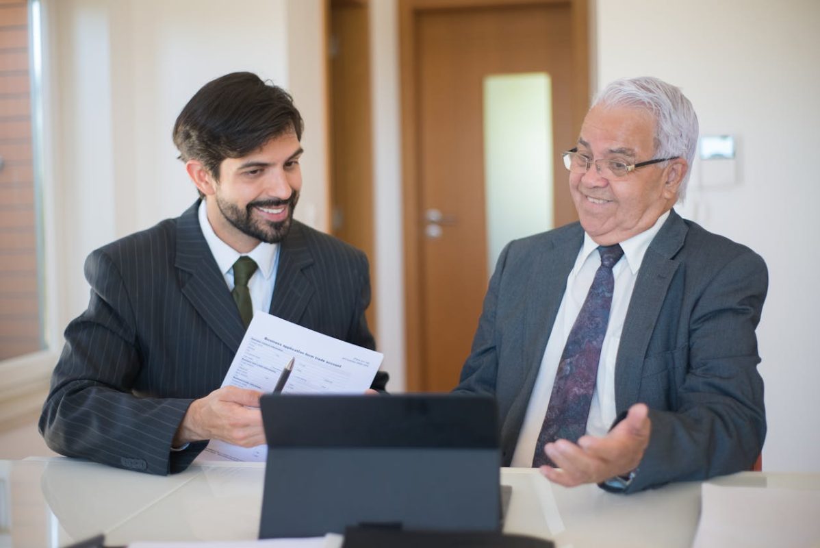 Online business salesman discussing online business opportunities to a senior man.