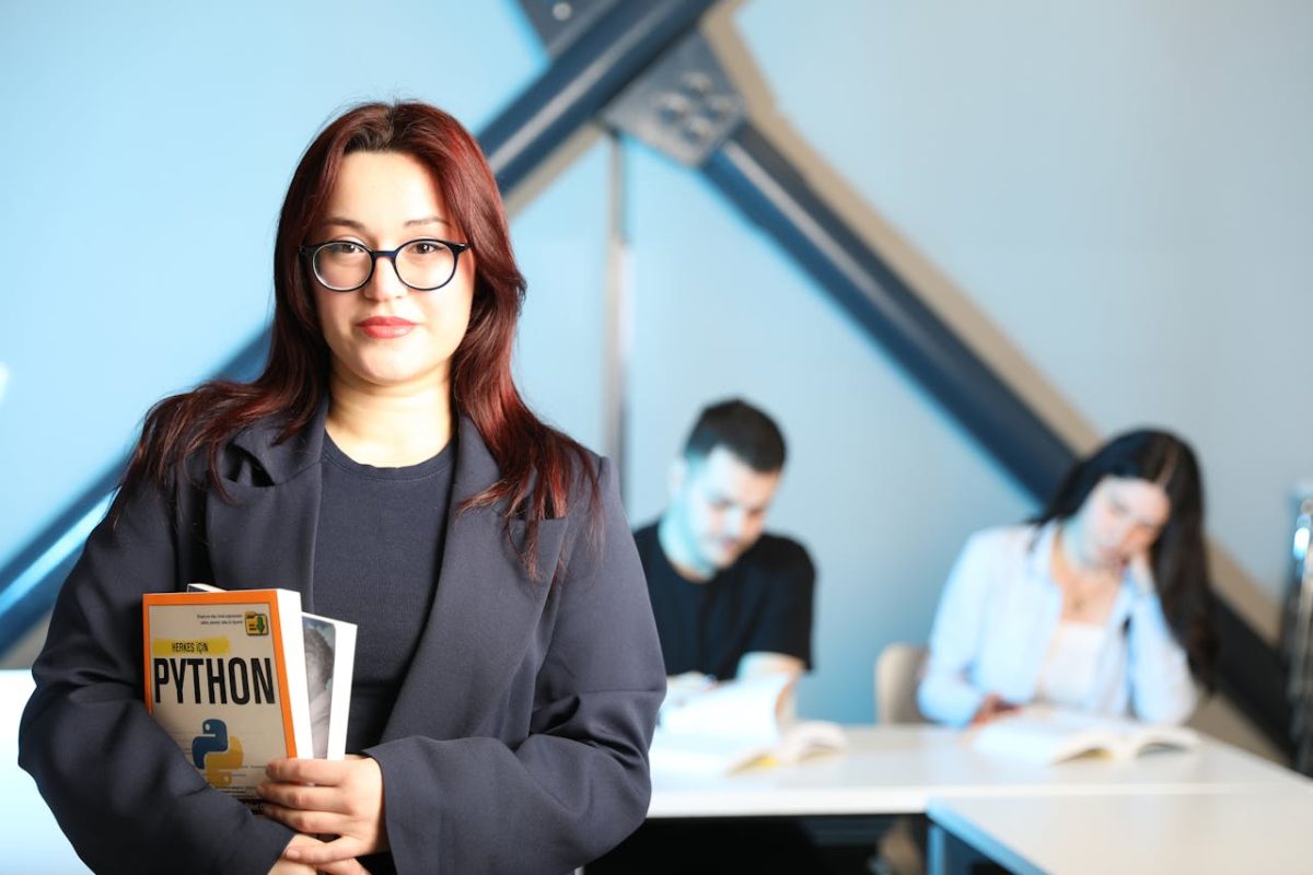 young-professional-holding-AI/ML python-book-in-class.